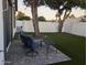 Turf backyard with shaded seating area and white fence for privacy at 8879 E Friess Dr, Scottsdale, AZ 85260