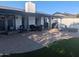 Spacious backyard with a brick patio, fire pit, outdoor seating, and lush green grass at 8879 E Friess Dr, Scottsdale, AZ 85260