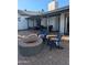 Charming backyard with a brick patio featuring a fire pit and cozy Adirondack chairs for relaxation at 8879 E Friess Dr, Scottsdale, AZ 85260