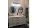 Bathroom features double sinks, oval mirrors, modern lighting, and a walk-in shower at 8879 E Friess Dr, Scottsdale, AZ 85260