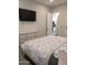 Spacious bedroom features a walk-in closet, TV, and a view into the white-cabinet kitchen at 8879 E Friess Dr, Scottsdale, AZ 85260