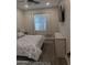Comfortable bedroom with neutral tones, modern lighting, large window, and TV for relaxation at 8879 E Friess Dr, Scottsdale, AZ 85260