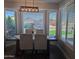 Bright dining area with a bay window, modern lighting, and a dark wood table with seating for four at 8879 E Friess Dr, Scottsdale, AZ 85260