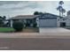 Charming single-story home featuring a well-maintained front yard, attached garage, and inviting curb appeal at 8879 E Friess Dr, Scottsdale, AZ 85260