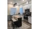Bright kitchen with white cabinets, stainless steel appliances, and a functional island with breakfast bar at 8879 E Friess Dr, Scottsdale, AZ 85260