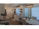 An open-concept kitchen and dining area with white cabinetry, stylish decor, and modern lighting fixtures at 8879 E Friess Dr, Scottsdale, AZ 85260