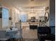 This open kitchen features stainless steel appliances, modern cabinets, and an island with bar seating at 8879 E Friess Dr, Scottsdale, AZ 85260