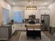 Stylish kitchen with white cabinets, stainless steel appliances, and a center island with seating at 8879 E Friess Dr, Scottsdale, AZ 85260