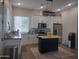 Well-lit kitchen with white cabinets, stainless steel appliances, and a functional center island at 8879 E Friess Dr, Scottsdale, AZ 85260