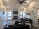 The vaulted living room showcases a fireplace, ample natural light, and a ceiling fan for comfort at 8879 E Friess Dr, Scottsdale, AZ 85260