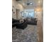 Open-concept living room with hardwood floors, comfortable seating, and ample natural light creating a welcoming space at 8879 E Friess Dr, Scottsdale, AZ 85260