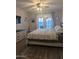 Inviting main bedroom with a ceiling fan, private outdoor access, and neutral decor at 8879 E Friess Dr, Scottsdale, AZ 85260