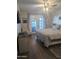A bright main bedroom with a ceiling fan, private outdoor access, and neutral decor at 8879 E Friess Dr, Scottsdale, AZ 85260