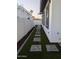 Side yard featuring artificial grass and stepping stones at 8879 E Friess Dr, Scottsdale, AZ 85260