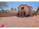 Expansive backyard featuring desert landscaping and a covered patio at 931 S Racine Ln, Gilbert, AZ 85296