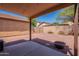 View of a private backyard featuring a covered patio and desert landscaping at 931 S Racine Ln, Gilbert, AZ 85296