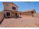 Wide angle view of the backyard with covered patio and desert landscaping at 931 S Racine Ln, Gilbert, AZ 85296