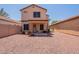 Large backyard featuring desert landscaping, covered patio, and privacy fence at 931 S Racine Ln, Gilbert, AZ 85296