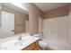 Clean bathroom with tub-shower combination, single sink vanity, and neutral tile at 931 S Racine Ln, Gilbert, AZ 85296