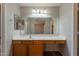A neutral bathroom features a sink vanity with mirror and lighting at 931 S Racine Ln, Gilbert, AZ 85296