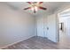 This bedroom features wood-look flooring, a ceiling fan, and a closet for storage at 931 S Racine Ln, Gilbert, AZ 85296