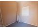 A small bedroom awaits renovation, featuring carpet flooring and a single window at 931 S Racine Ln, Gilbert, AZ 85296