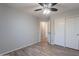 Bedroom featuring wood-look floors, closet with double doors, and a ceiling fan at 931 S Racine Ln, Gilbert, AZ 85296