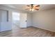 A well-lit bedroom with wood-look flooring, neutral paint, and a ceiling fan at 931 S Racine Ln, Gilbert, AZ 85296