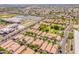 A vibrant neighborhood seen from above, complete with a school, lush landscaping, and varied home styles at 931 S Racine Ln, Gilbert, AZ 85296