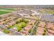 Aerial view showcasing the community layout with green spaces, a pool, and houses with well-maintained yards at 931 S Racine Ln, Gilbert, AZ 85296