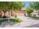 Single Gathering home featuring a two-car garage, and a well kept lawn with mature trees at 931 S Racine Ln, Gilbert, AZ 85296