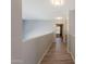 Well-lit upper level hallway with wood-look flooring leads to secondary bedrooms at 931 S Racine Ln, Gilbert, AZ 85296