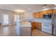 Bright kitchen features stainless steel appliances, wood cabinetry, and a breakfast bar overlooking the dining area at 931 S Racine Ln, Gilbert, AZ 85296
