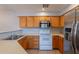 A well-lit kitchen with stainless steel appliances and light wood cabinets provides a functional space for cooking at 931 S Racine Ln, Gilbert, AZ 85296