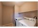 Convenient laundry room showcasing a modern washer and dryer, as well as tile floors at 931 S Racine Ln, Gilbert, AZ 85296