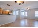 Open-concept living space featuring neutral tones, tile flooring, and a seamless flow into the kitchen area at 931 S Racine Ln, Gilbert, AZ 85296