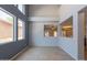 Open living room featuring high ceilings, tile flooring, and large windows for natural light at 931 S Racine Ln, Gilbert, AZ 85296