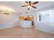 Open-concept living room flows into kitchen with stainless steel appliances and natural wood cabinets at 931 S Racine Ln, Gilbert, AZ 85296