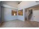 Open living room boasting large windows, tile flooring, and open views of the dining room and staircase at 931 S Racine Ln, Gilbert, AZ 85296