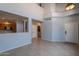 Spacious living room with tile floors, offering views into the kitchen and access to the entry at 931 S Racine Ln, Gilbert, AZ 85296