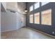 Living room with soaring ceilings, tile flooring and a large window allowing natural light at 931 S Racine Ln, Gilbert, AZ 85296