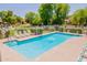 A community pool offers a refreshing escape on a sunny day with lounge chairs and a gated area for safety at 931 S Racine Ln, Gilbert, AZ 85296
