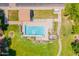 Aerial view of a refreshing community pool area featuring lounge chairs, a covered seating area, and lush landscaping at 931 S Racine Ln, Gilbert, AZ 85296