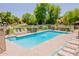 A community pool offers a refreshing escape on a sunny day with lounge chairs and a gated area for safety at 931 S Racine Ln, Gilbert, AZ 85296