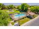 Aerial view of a well-maintained community pool, playground, and landscaped green space for residents to enjoy at 931 S Racine Ln, Gilbert, AZ 85296