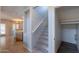 Stairway leads to upper level, adjacent to open living space, and offers natural light at 931 S Racine Ln, Gilbert, AZ 85296