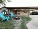 Inviting backyard featuring a fire pit and covered patio with chairs, ideal for outdoor relaxation at 9615 N 34Th Ave, Phoenix, AZ 85051