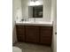 Bathroom with white countertop, brown cabinets, and modern sink fixture at 9615 N 34Th Ave, Phoenix, AZ 85051