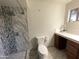 Updated bathroom featuring a marble shower and modern fixtures at 9615 N 34Th Ave, Phoenix, AZ 85051