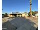 Front view of house shows the large driveway, desert landscaping, and solar panels on the roof at 9615 N 34Th Ave, Phoenix, AZ 85051